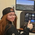 Brook Kirby at the controls of a flight simulator